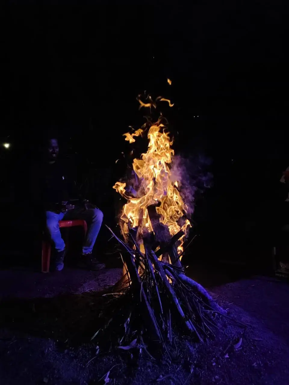 Campfire burning at night on a Voycan trip